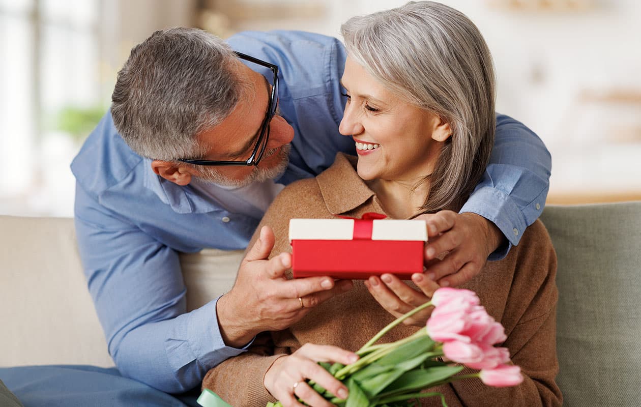 Elderly couple exchange gift box