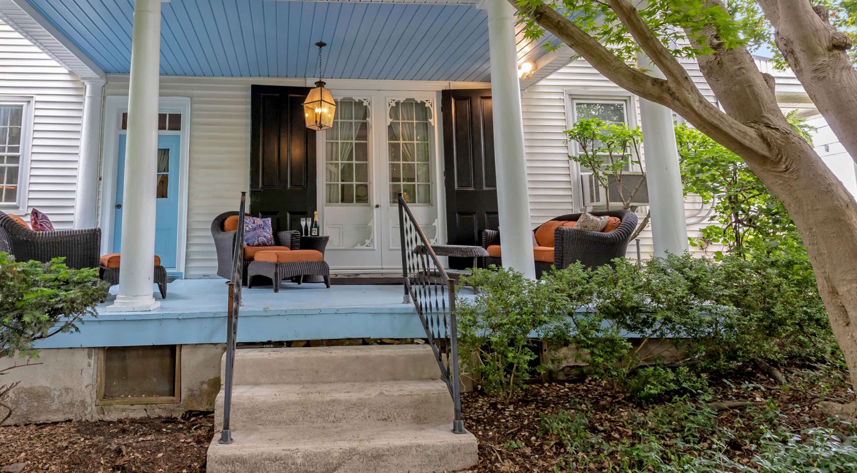 Blue porch with seating and Champagne