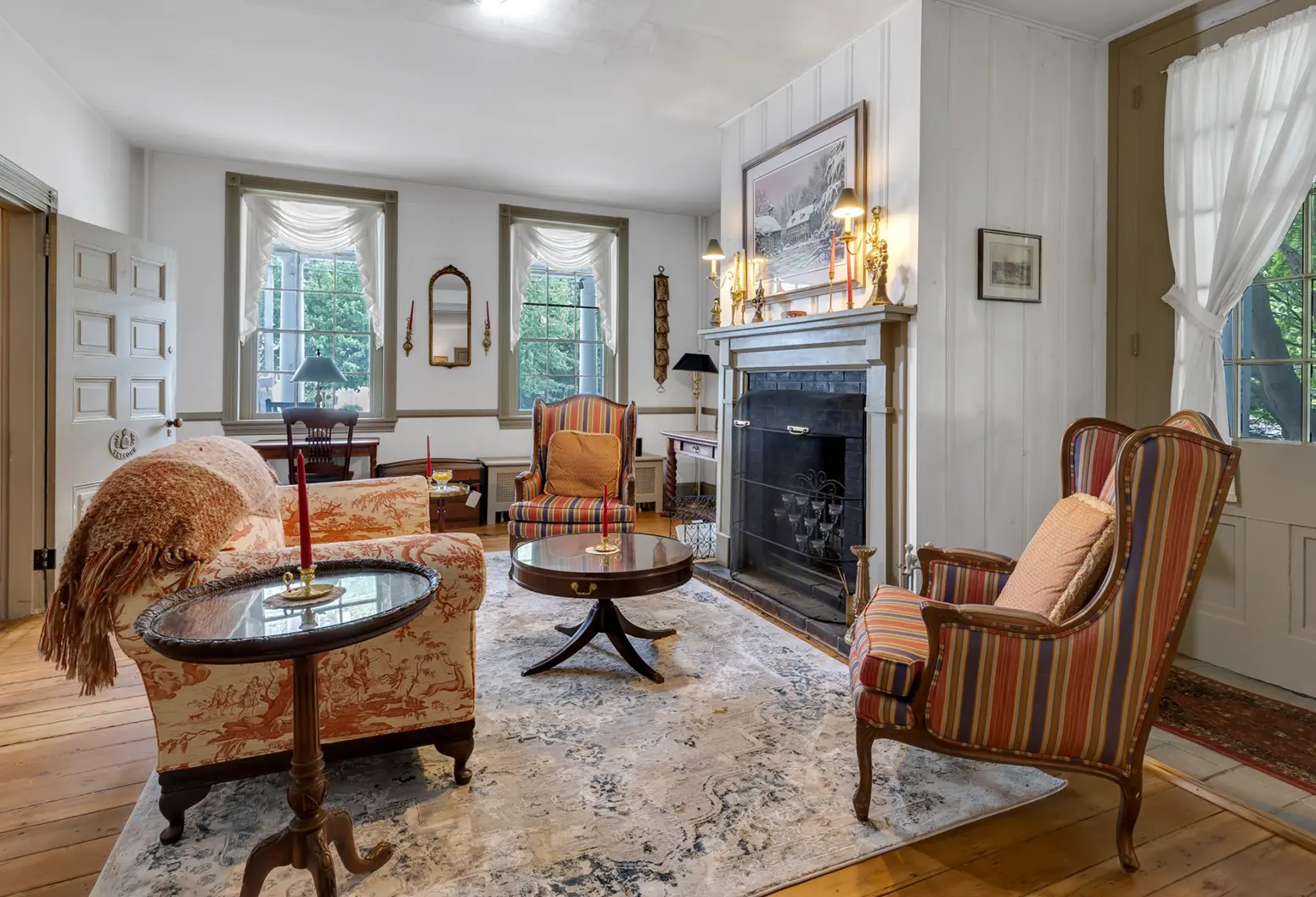 Parlor with chairs and fireplace