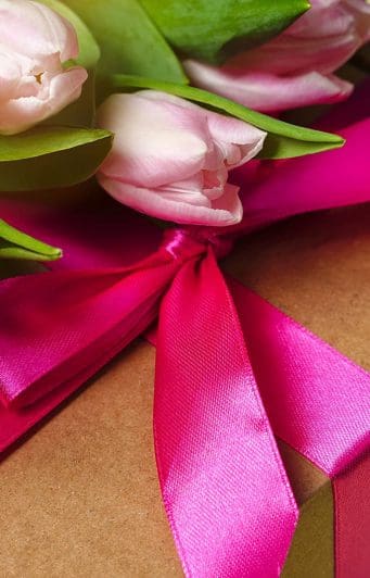 Roses sit on top of a box containing a gift certificate to the Inn at Twin Linden