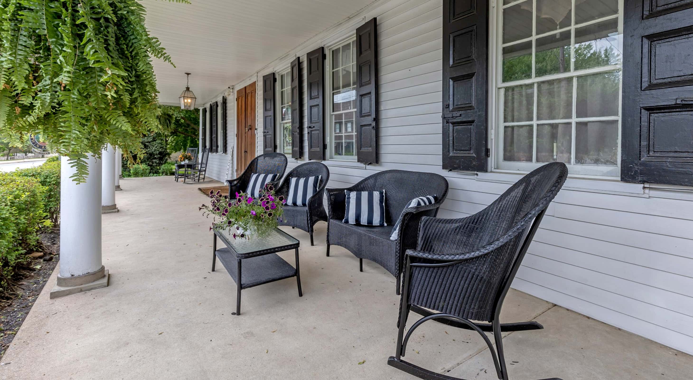 welcoming porch with black chairs 